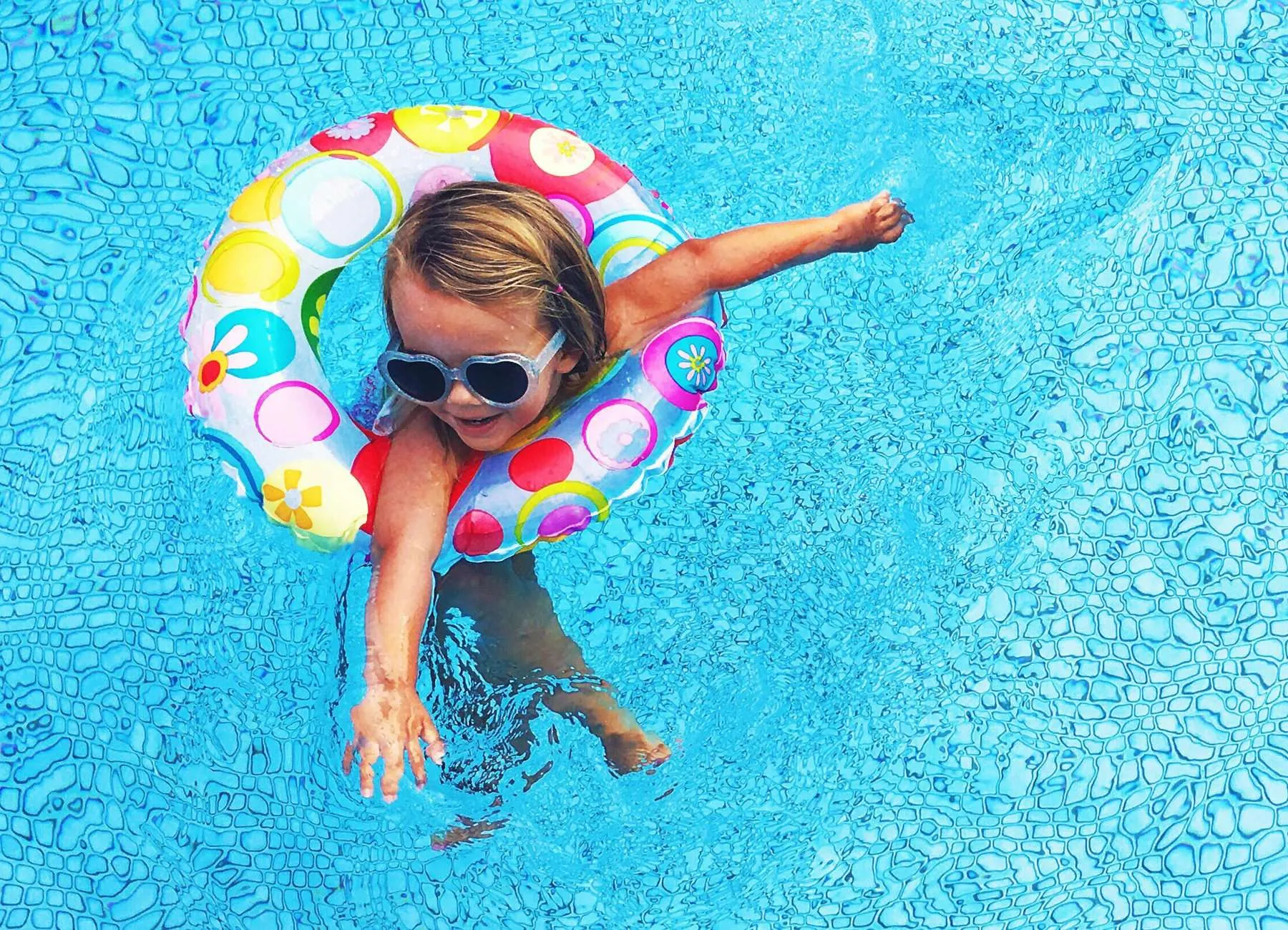 A child using a floating ring in a pool